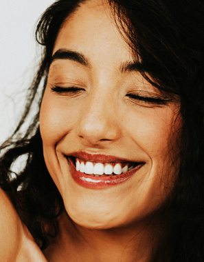 Signature Dental Aesthetics organic woman smiling eyes shut