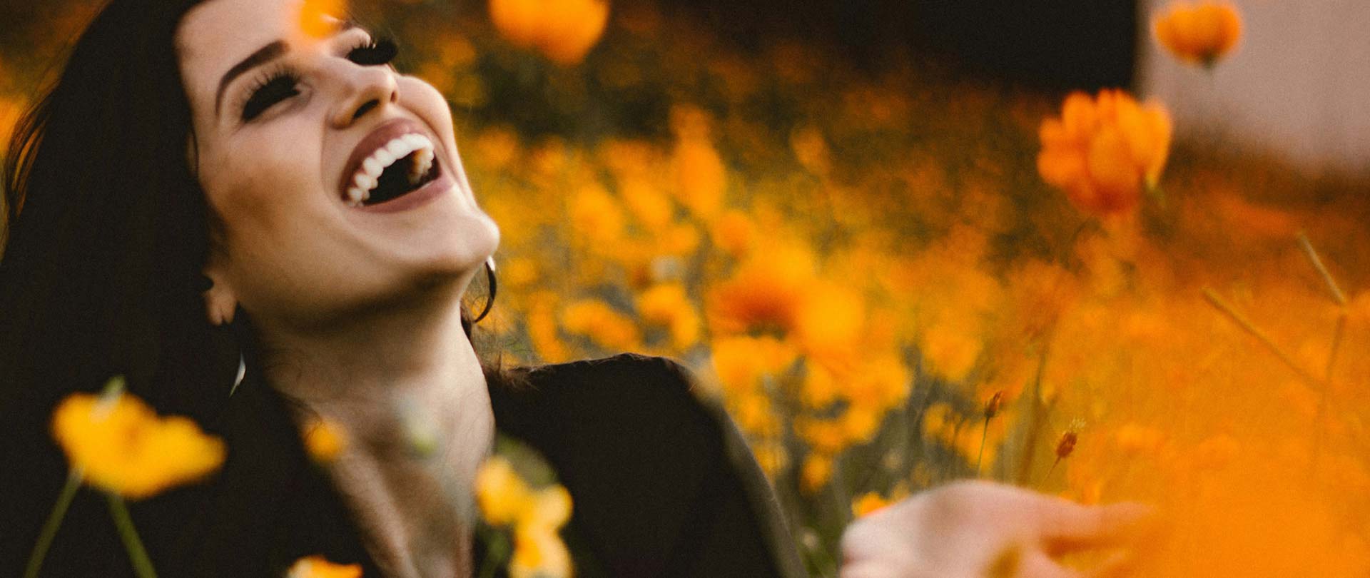 Signature Dental Aesthetics woman smiling in field with flowers