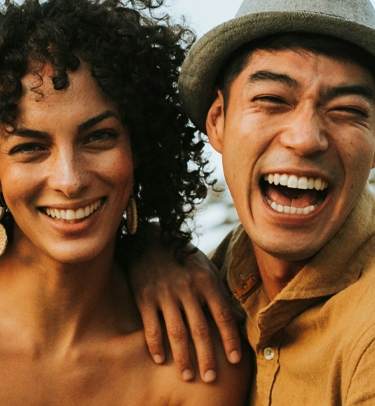 Signature Dental Aesthetics male and woman smiling mobile