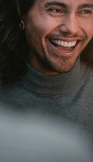 Signature Dental Aesthetics smiling with visible teeth mobile