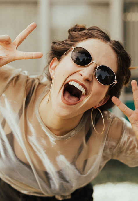 Signature Dental Aesthetics woman in sunglasses posing